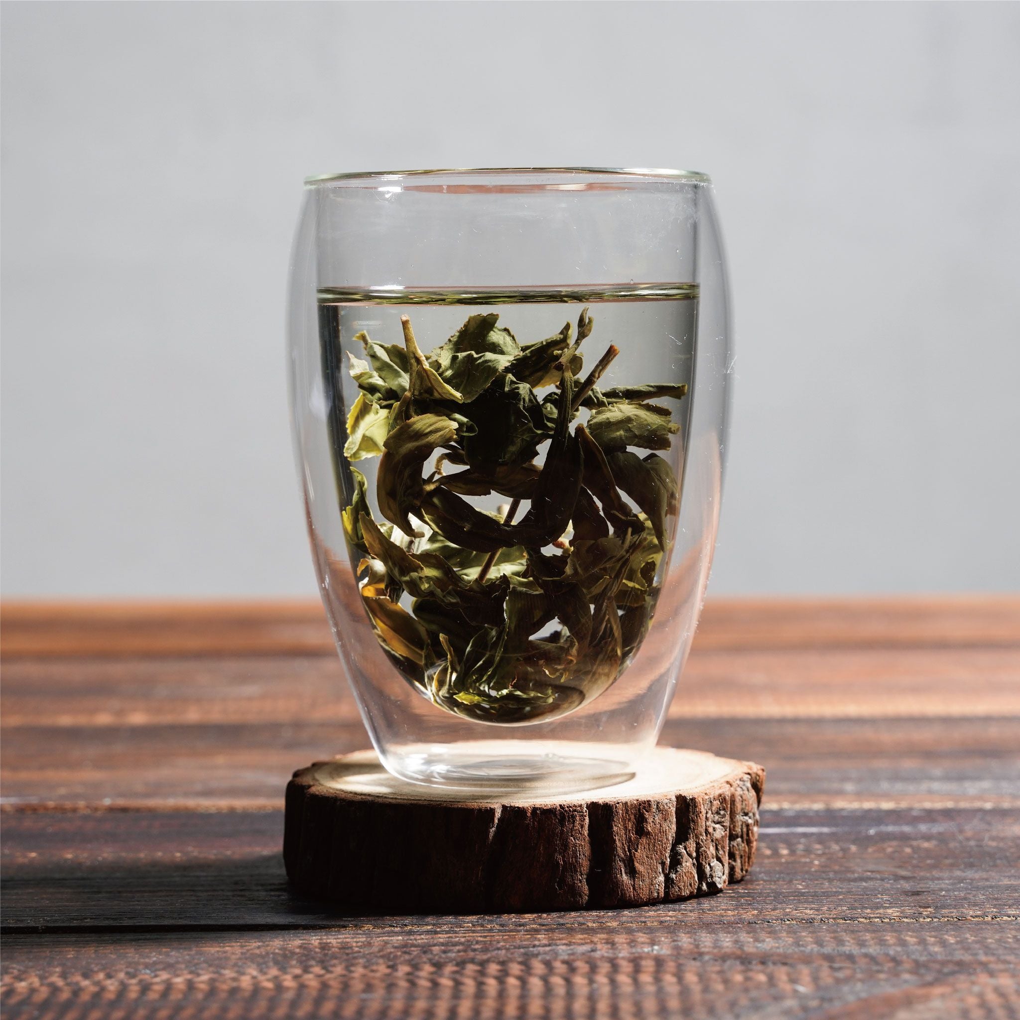 bao zhong wrapped kind wet leaves floating in cup