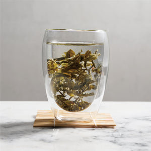 gui hua osmanthus green tea wet tea leaves floating in cup