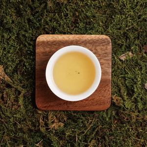 long jing dragon well tea liquor in cup