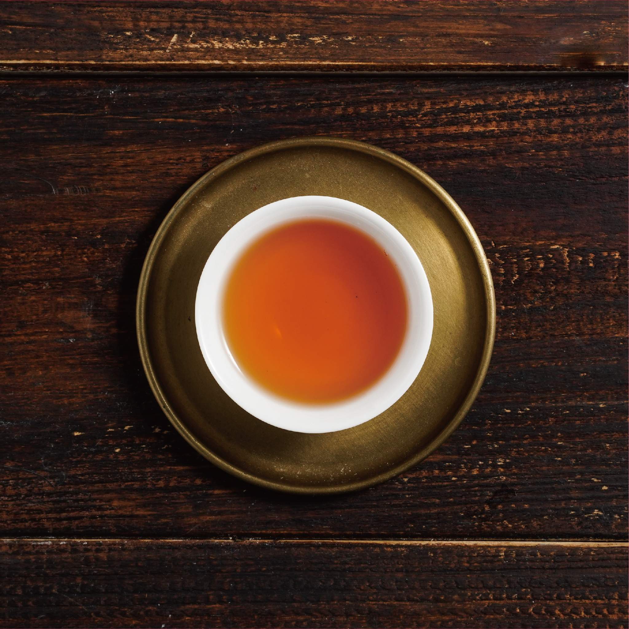 tie guan yin iron goddess of mercy tea liquor in cup