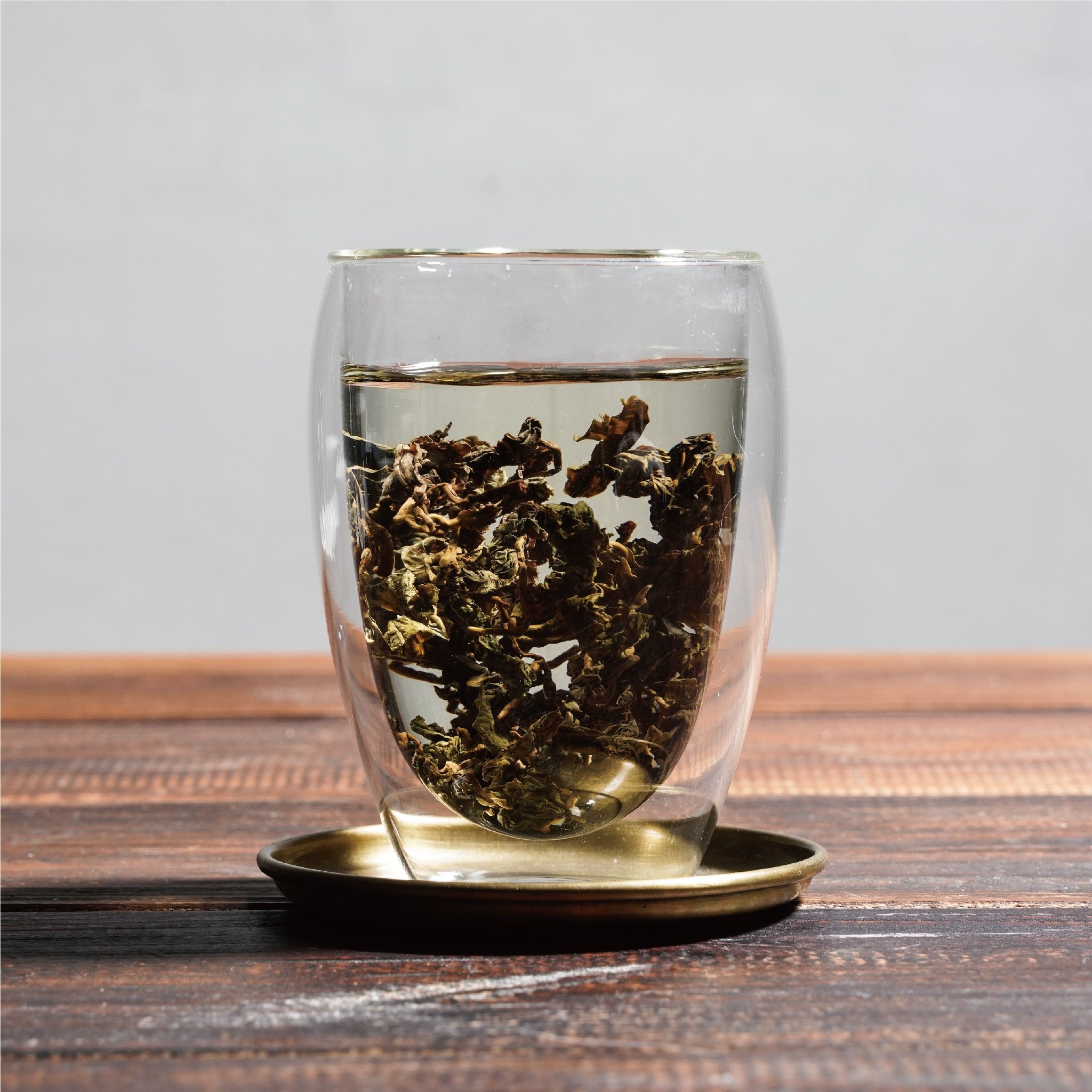 tie guan yin iron goddess of mercy wet tea leaves floating in cup